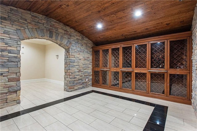 wine room with light tile patterned floors and wooden ceiling