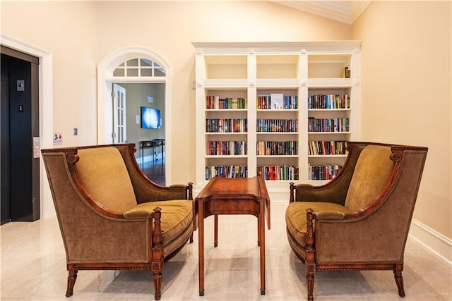 sitting room with vaulted ceiling, crown molding, and elevator