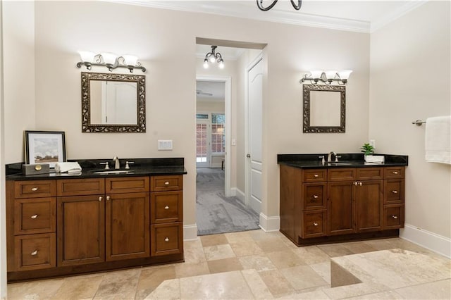 bathroom with vanity, ornamental molding, and a notable chandelier