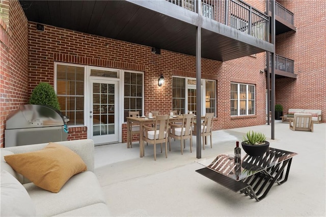 view of patio / terrace with an outdoor kitchen, a balcony, and grilling area