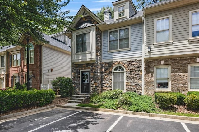 1244 Harris Commons Pl, Roswell, GA 30076 - view of property featuring uncovered parking and stone siding