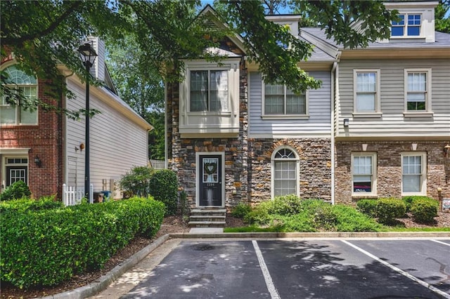1244 Harris Commons Pl, Roswell, GA 30076 - view of property featuring uncovered parking and stone siding