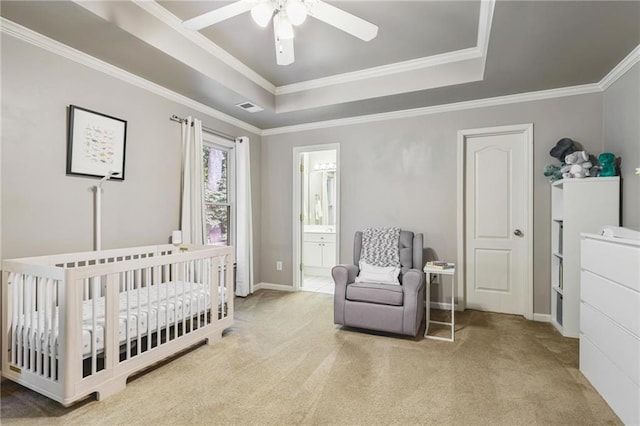 1244 Harris Commons Pl, Roswell, GA 30076 - carpeted bedroom featuring a tray ceiling, crown molding, a nursery area, a ceiling fan, and ensuite bath