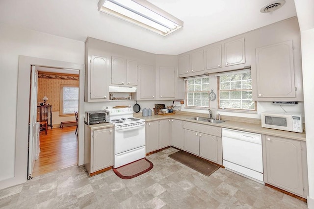 970 E Main St, Canton, GA 30114 - kitchen featuring under cabinet range hood, white appliances, a sink, visible vents, and light countertops