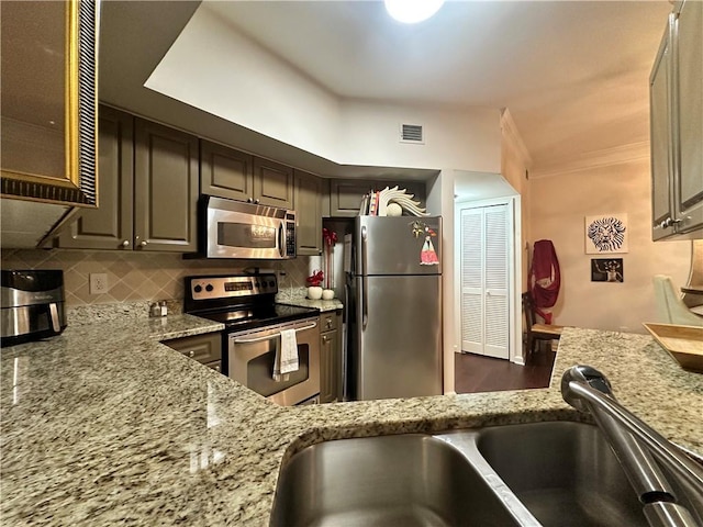 200 Renaissance Pkwy NE Unit 305, Atlanta, GA 30308 - kitchen featuring appliances with stainless steel finishes, light stone counters, a sink, and backsplash