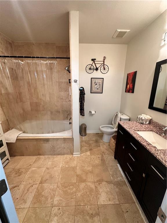 200 Renaissance Pkwy NE Unit 305, Atlanta, GA 30308 - full bath with tiled shower / bath, vanity, toilet, baseboards, and tile patterned floors