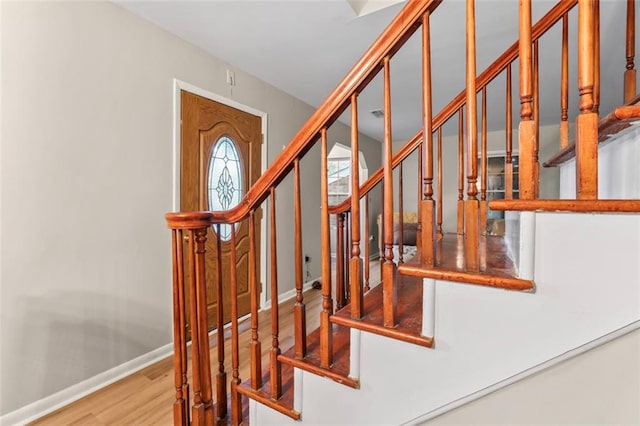 staircase featuring wood-type flooring