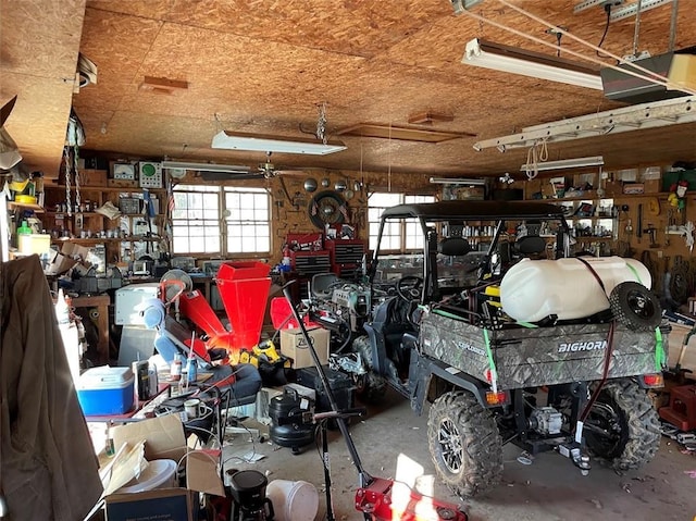 garage with a workshop area and a garage door opener