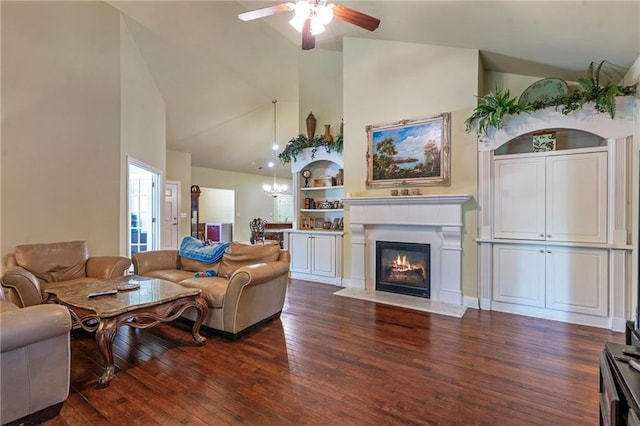 living area with a fireplace with flush hearth, high vaulted ceiling, ceiling fan with notable chandelier, and dark wood-style floors