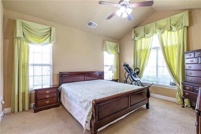 bedroom featuring ceiling fan, light colored carpet, visible vents, vaulted ceiling, and baseboards
