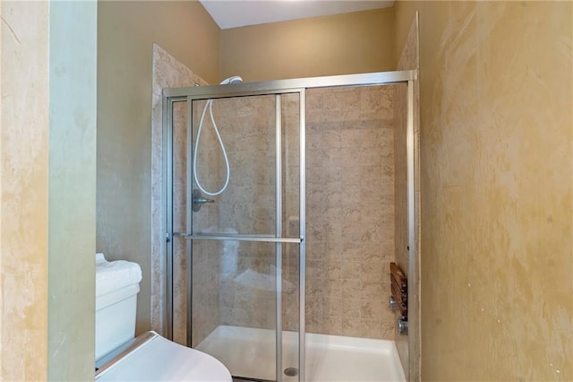 full bathroom with toilet and a shower stall