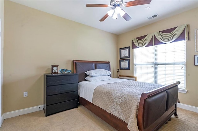 bedroom featuring visible vents, a ceiling fan, baseboards, and light carpet