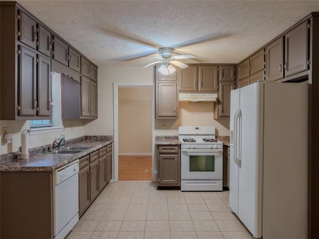 kitchen with white appliances, under cabinet range hood, dark countertops, ceiling fan, and a textured ceiling