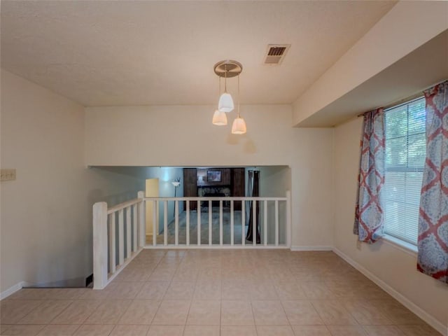 unfurnished room with baseboards