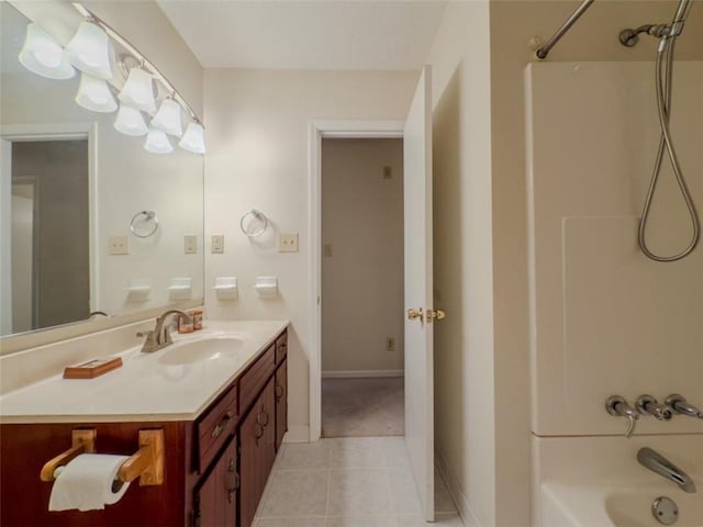bathroom with shower / washtub combination, tile patterned floors, vanity, and baseboards