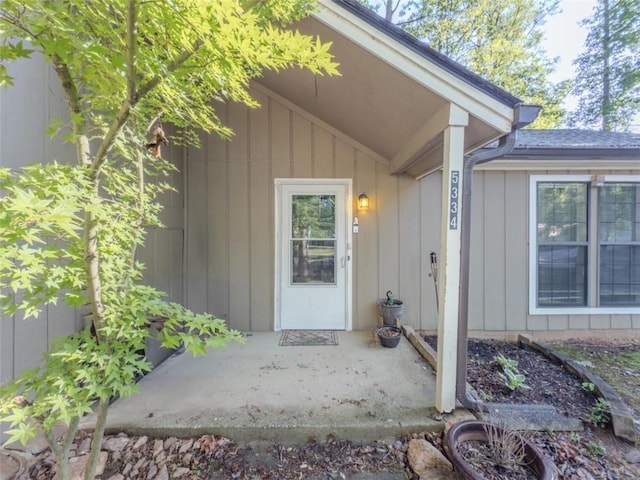 doorway to property featuring a patio and board and batten siding