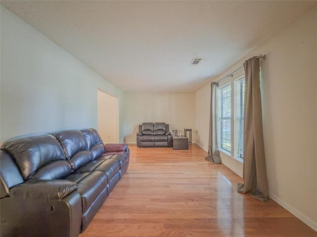 living area with light wood finished floors and baseboards