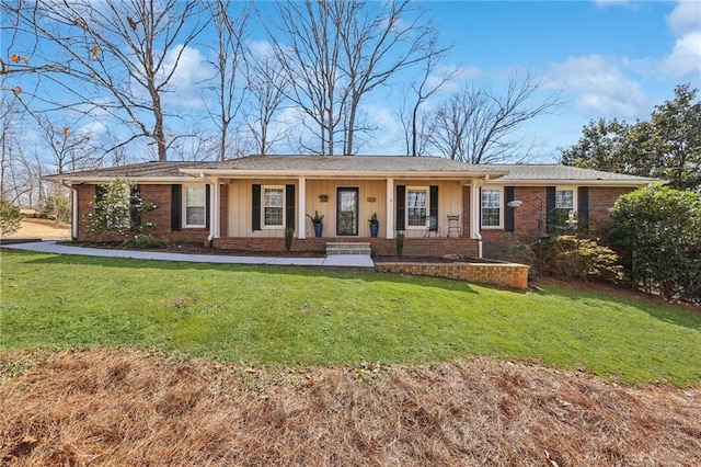 ranch-style home featuring a front lawn, board and batten siding, and brick siding