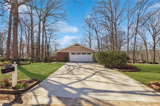 view of side of property featuring a garage, brick siding, and a lawn