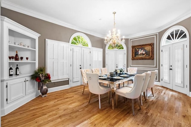 4670 Hamden Forest Dr SW, Atlanta, GA 30331 - dining room with a chandelier, crown molding, and light wood-style floors