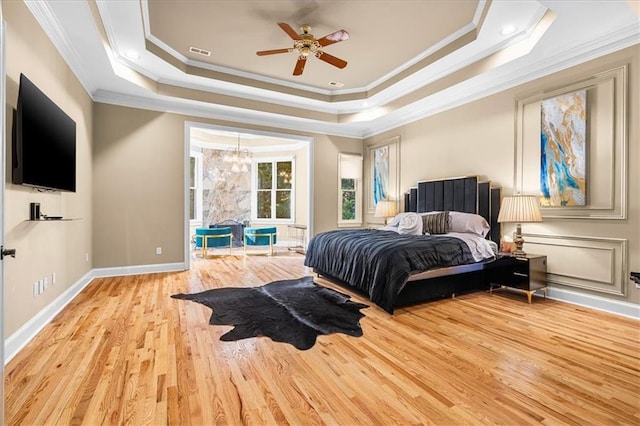 4670 Hamden Forest Dr SW, Atlanta, GA 30331 - bedroom with crown molding, wood finished floors, a tray ceiling, a chandelier, and baseboards