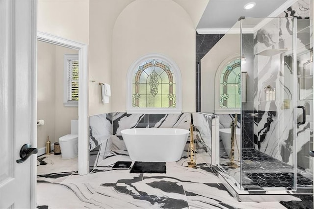 4670 Hamden Forest Dr SW, Atlanta, GA 30331 - full bathroom with marble tiled flooring, tile walls, toilet, a freestanding bath, and a marble finish shower