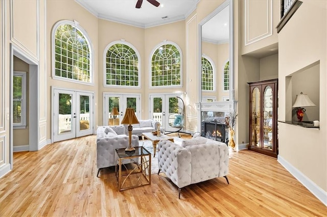 4670 Hamden Forest Dr SW, Atlanta, GA 30331 - living room with french doors, a high ceiling, a high end fireplace, ceiling fan, and light wood-type flooring