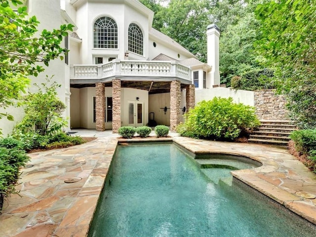 4670 Hamden Forest Dr SW, Atlanta, GA 30331 - back of property featuring french doors, stucco siding, a patio area, and a chimney