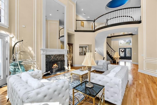 4670 Hamden Forest Dr SW, Atlanta, GA 30331 - living room with a towering ceiling, stairs, plenty of natural light, wood finished floors, and a fireplace
