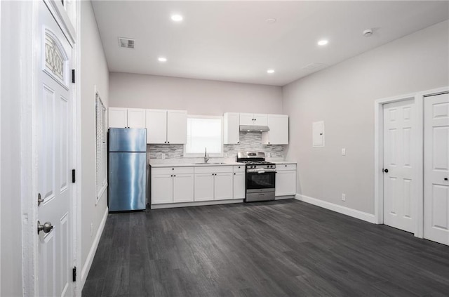 1156 Clinton Rd, Macon, GA 31211 - kitchen with stainless steel appliances, baseboards, white cabinetry, a sink, and dark wood-style floors