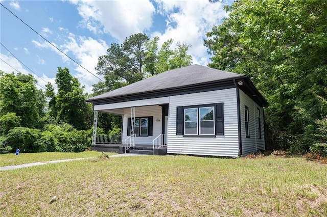 1156 Clinton Rd, Macon, GA 31211 - view of front of property featuring covered porch and a front yard