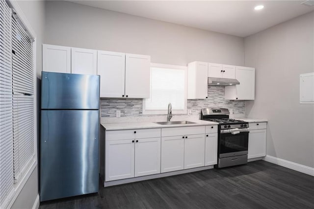 1156 Clinton Rd, Macon, GA 31211 - kitchen with stainless steel appliances, a sink, under cabinet range hood, dark wood-style floors, and recessed lighting