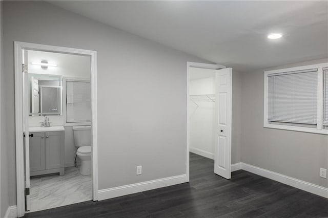 1156 Clinton Rd, Macon, GA 31211 - unfurnished bedroom with baseboards, a spacious closet, a sink, connected bathroom, and recessed lighting