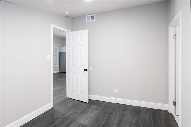 1156 Clinton Rd, Macon, GA 31211 - unfurnished room with baseboards, dark wood-style floors, and a smoke detector