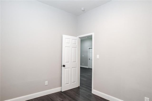 1156 Clinton Rd, Macon, GA 31211 - spare room featuring baseboards, dark wood-style floors, and a smoke detector