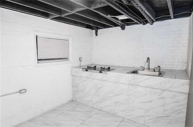 1156 Clinton Rd, Macon, GA 31211 - bathroom with a sink, concrete block wall, and marble finish flooring
