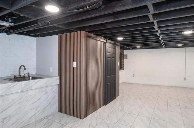 1156 Clinton Rd, Macon, GA 31211 - finished basement with a sink and light marble finish flooring