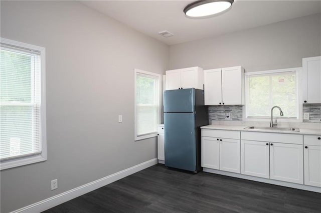 1156 Clinton Rd, Macon, GA 31211 - kitchen featuring freestanding refrigerator, a sink, white cabinets, dark wood-style flooring, and tasteful backsplash