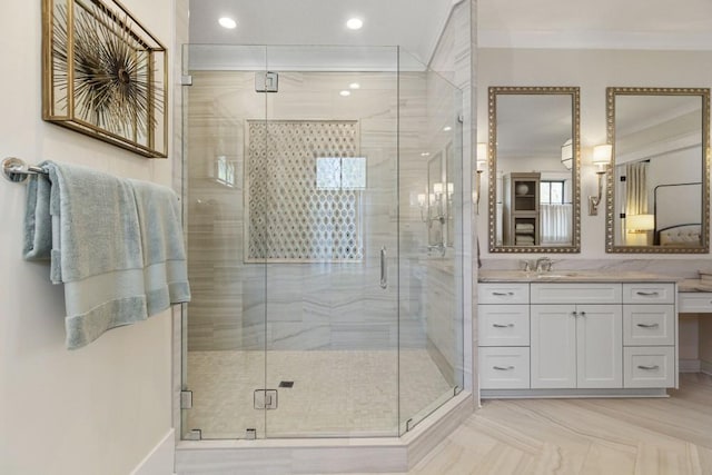 bathroom featuring crown molding, vanity, a stall shower, and recessed lighting
