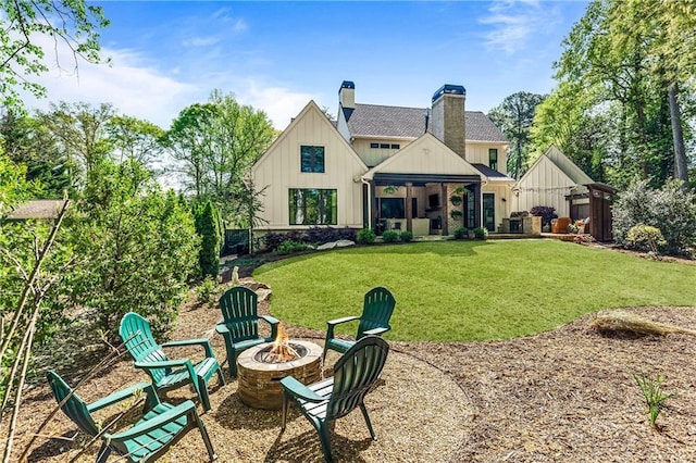 284 Hook St, Alpharetta, GA 30009 - rear view of property featuring an outdoor fire pit, board and batten siding, a lawn, a chimney, and a gazebo