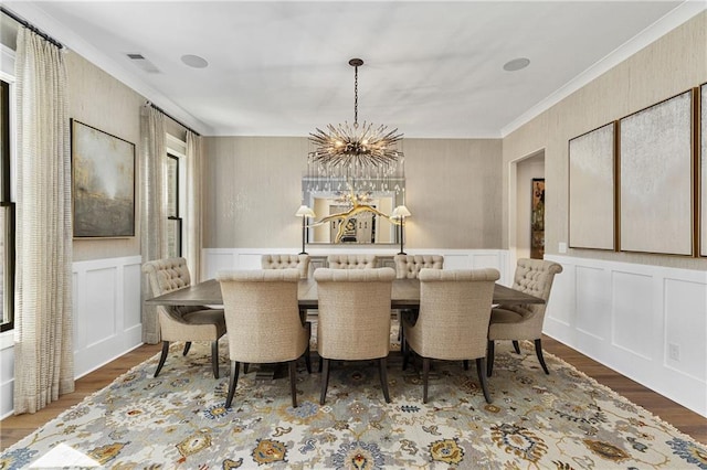 284 Hook St, Alpharetta, GA 30009 - dining area with a chandelier, ornamental molding, wood finished floors, a decorative wall, and wainscoting