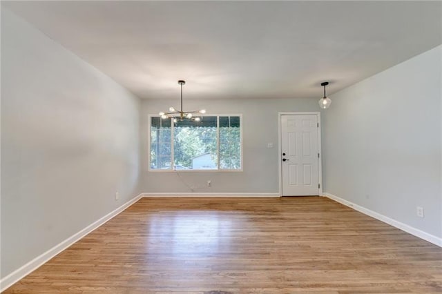 3991 Adamsville Dr SW, Atlanta, GA 30331 - empty room with light wood-style flooring and a chandelier