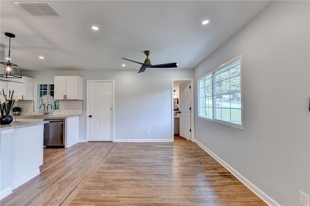 3991 Adamsville Dr SW, Atlanta, GA 30331 - kitchen with dishwasher, ceiling fan, white cabinetry, light wood-type flooring, and recessed lighting