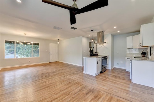 3991 Adamsville Dr SW, Atlanta, GA 30331 - kitchen with stainless steel range with electric cooktop, range hood, light wood-type flooring, decorative backsplash, and white cabinetry