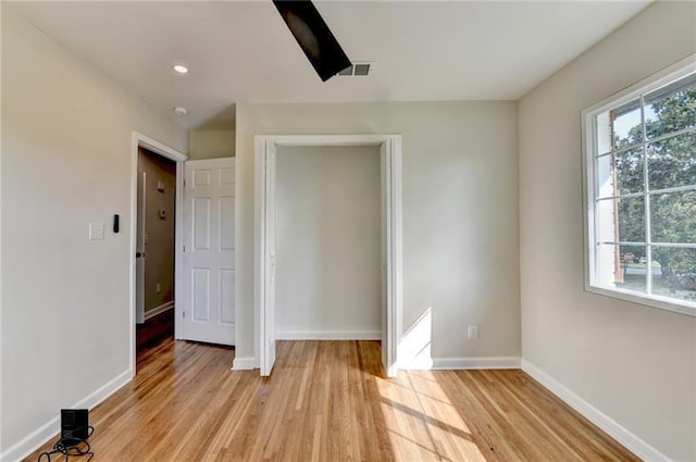 3991 Adamsville Dr SW, Atlanta, GA 30331 - unfurnished bedroom with multiple windows, light wood-type flooring, and recessed lighting