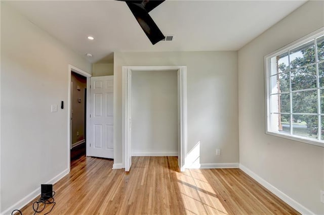 3991 Adamsville Dr SW, Atlanta, GA 30331 - unfurnished bedroom with multiple windows, light wood-type flooring, recessed lighting, and ceiling fan