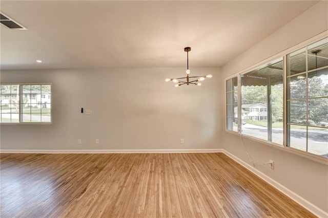 3991 Adamsville Dr SW, Atlanta, GA 30331 - spare room featuring wood finished floors, a chandelier, healthy amount of natural light, and recessed lighting