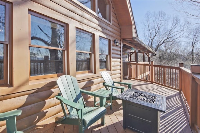 wooden terrace with an outdoor fire pit