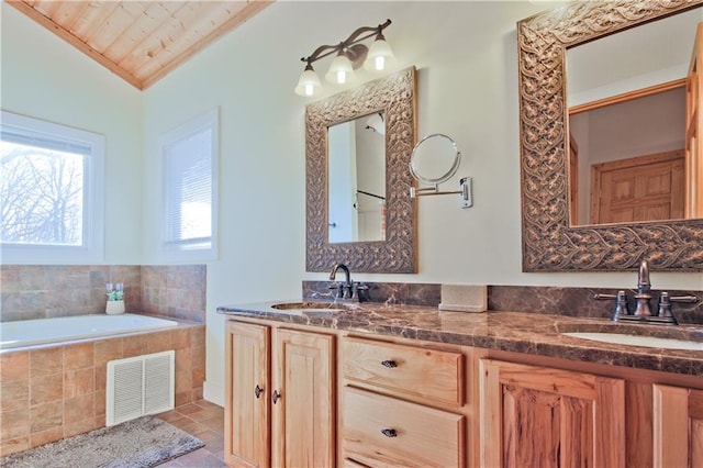 full bath with tile patterned flooring, visible vents, a sink, and lofted ceiling