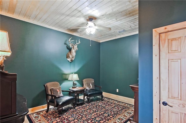 living area with wood ceiling, ceiling fan, baseboards, and wood finished floors